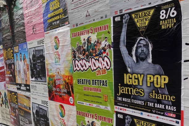 Athens, Greece - May 20, 2019: Rock music concert posters for live performances by Iggy Pop Locomondo and Wire plastered on city wall.