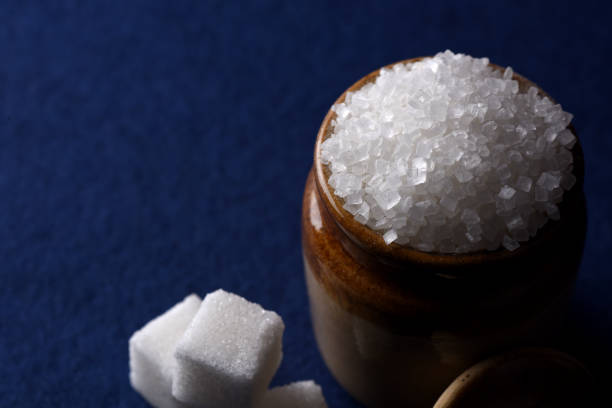 istock Sugar. white granulated sugar and refined sugar on a blue background 1197486024