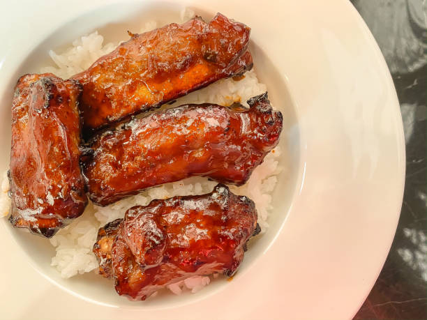 istock Pork rib with barbecue sauce served on rice in white dish 1197487105