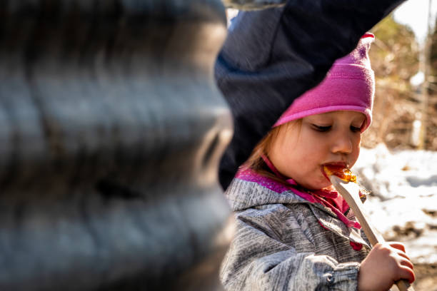 istock Little girl at a sugar shack. 1197490539