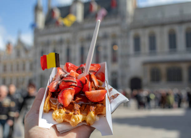 Traditional Belgian waffle dessert Traditional Belgian waffle dessert. Delicious cake with chocolate and fruits with flag. city of brussels stock pictures, royalty-free photos & images