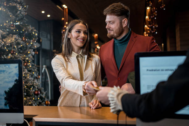 Wealthy couple checking in at hotel reception