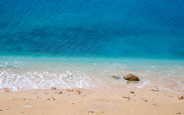 istock Turquoise colored sea and stones on beach. 1197492226