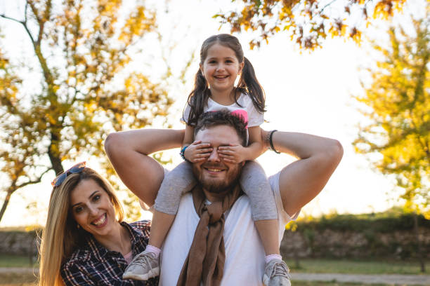 istock Father carrying daughter on shoulders 1197493588