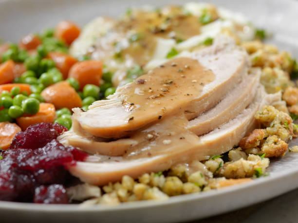 istock Roast Turkey Dinner With Stuffing, Mashed Potatoes, Cranberry Sauce, Peas, Carrots and Gravy 1197494028