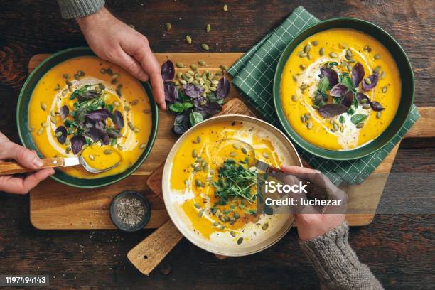 Men Eating Vegan Creamy Roasted Pumpkin Soup Stock Photo - Download Image Now - Soup, Food, Autumn