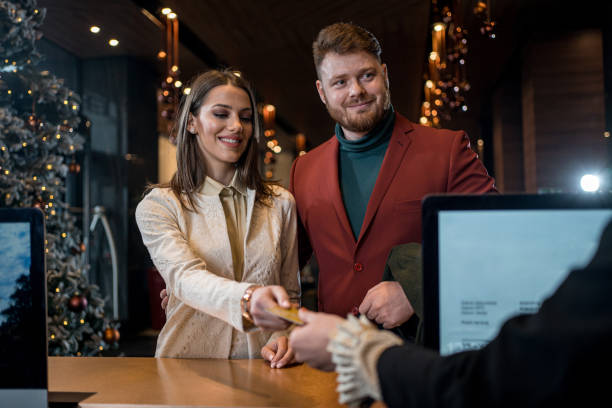 istock Young elegant couple at reception desk 1197494790