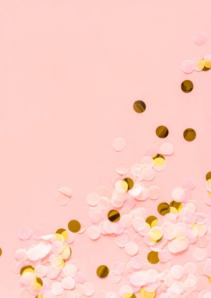 istock Gold and light pink confetti on a pink background, copy space 1197495144