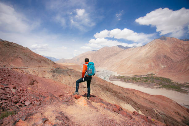 Man hiker with arms raised Annapurna trek, Nepal