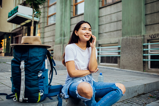 Girl sitting on the ground and talking on the phone