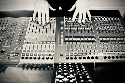 Mixing desk close-up. The image shows buttons and knobs of a sound studio mixing desk.