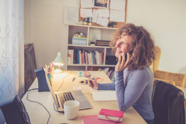 istock Curly Woman working from Home Office 1197504516
