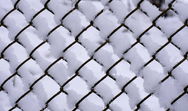 istock background mesh made of metal wire with snow 1197506564