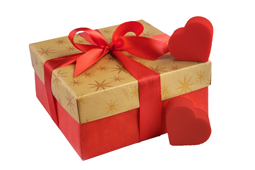 Red gift or present box with golden colored top and red ribbon bow, two hearts isolated on white background, for sales, birthday, valentine, mother day or christmas