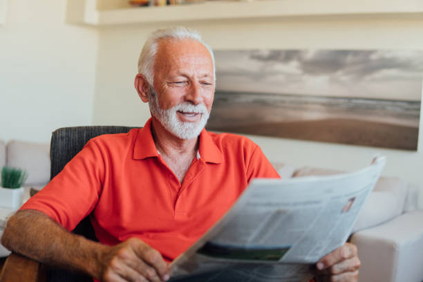 Senior man reading news papers