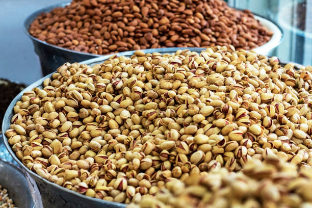 istock Heap of delicious fresh nuts (pistachios and almonds) in the eastern bazaar. 1197509441