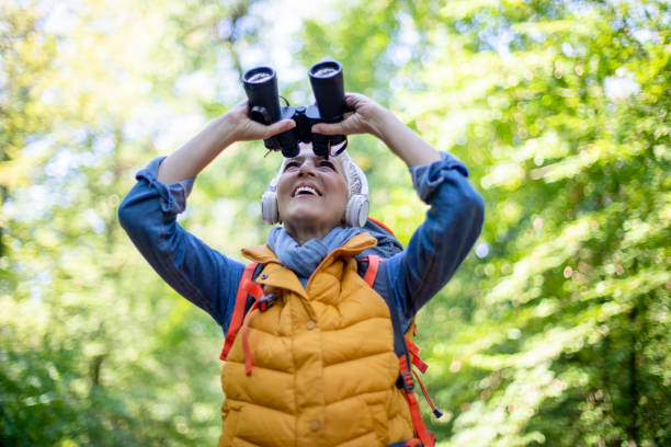istock Senior women with binoculars in spring forest. 1197509952