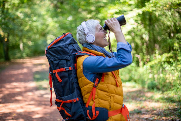 istock Happy senior women hiking in spring forest. 1197510657