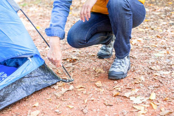 istock Unknown women hiking in forest with her tent. 1197510691