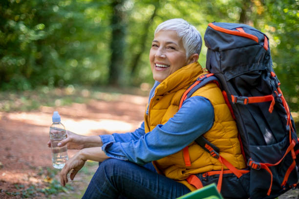 istock Senior women hiking in spring forest. 1197510822