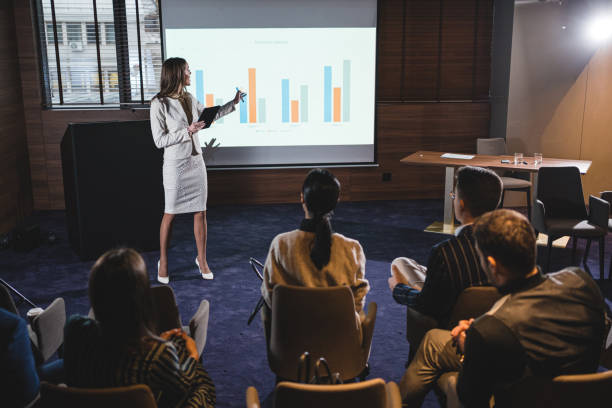 istock Female CEO pressenting new ideas to boarding members 1197510893