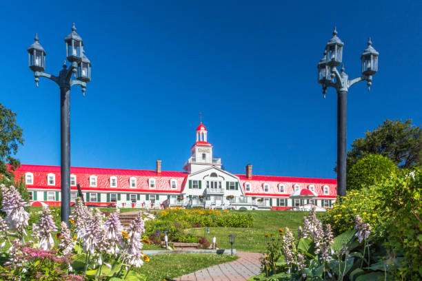 Front view of Hotel Tadoussac, Tadoussac, Quebec, Canada with street lamps and pathway to the hotel. Front view of Hotel Tadoussac, Tadoussac, Quebec, Canada with street lamps and pathway to the hotel. cote nord photos stock pictures, royalty-free photos & images