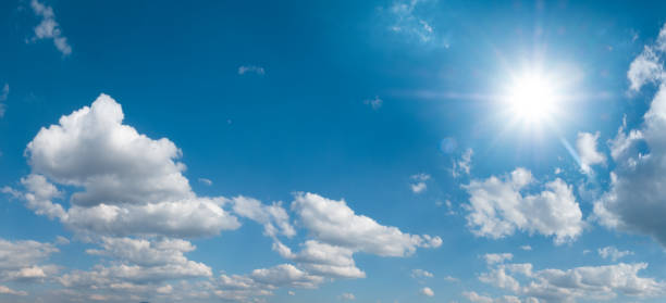 istock Beautiful blue sky with white clouds and sun, sunlight background 1197511985
