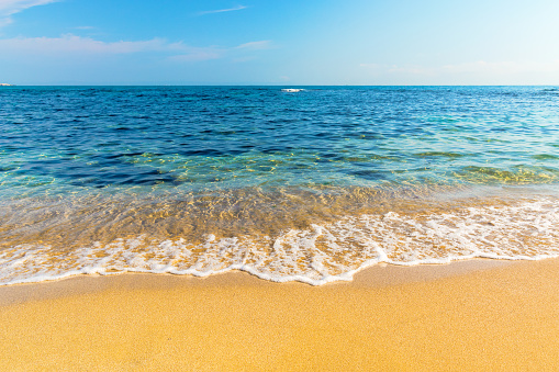 sea scenery in summer. beach with golden sand. wonderful vacation background with transparent calm waves and blue sky