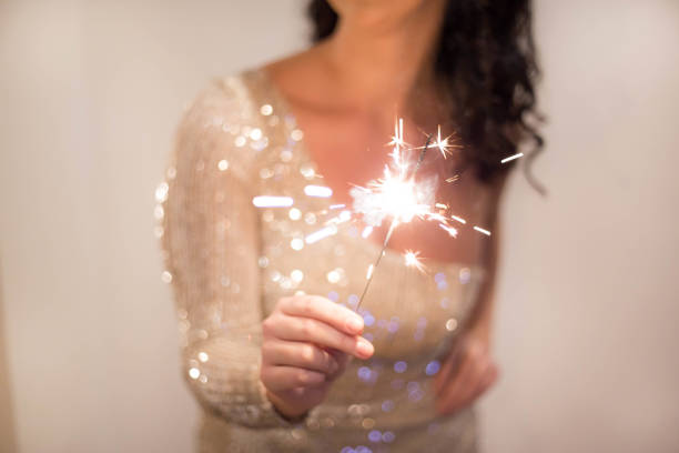 Close up of woman with New Year's sparklers