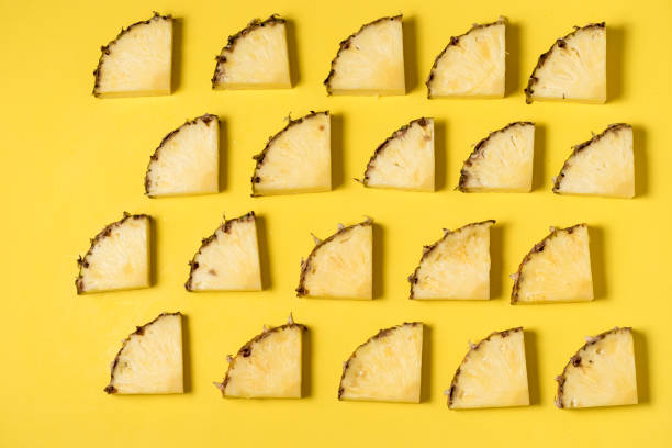 istock fresh and juicy pineapple pieces on a yellow homogeneous surface 1197516502