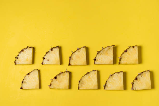 istock fresh and juicy pineapple pieces on a yellow homogeneous surface 1197516527