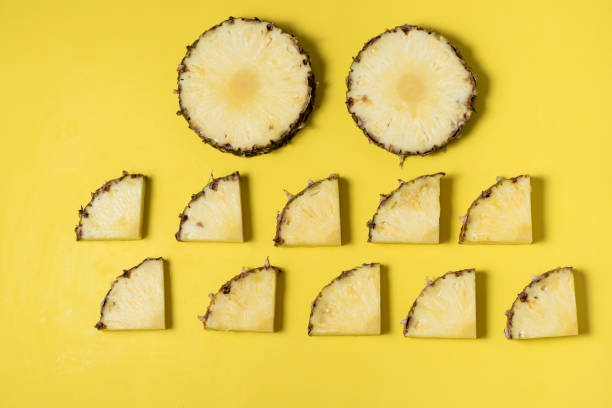istock fresh and juicy pineapple pieces on a yellow homogeneous surface 1197516530