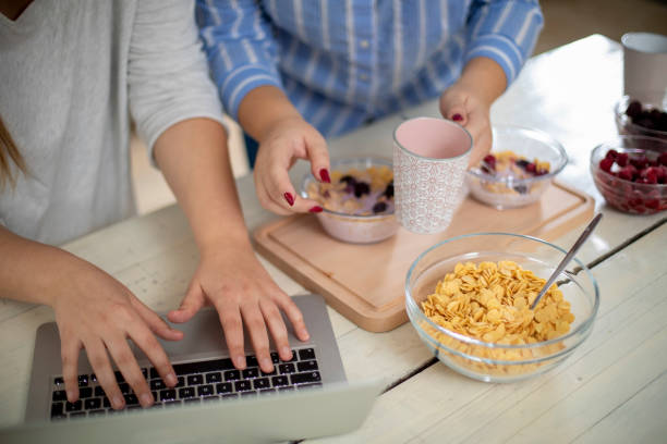 istock Female hands making healthy breakfast and using modern tehnology. 1197516563