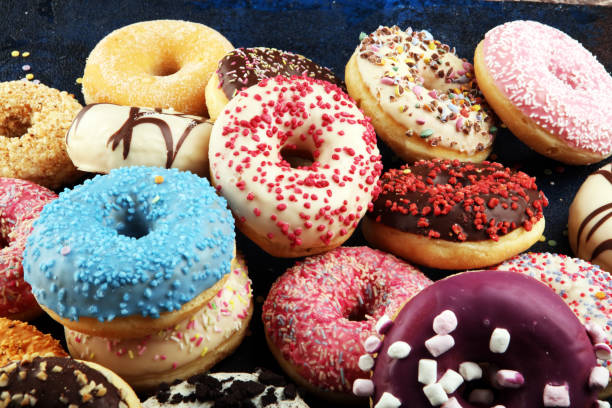 istock assorted donuts with chocolate frosted, pink glazed and sprinkles donuts 1197516606