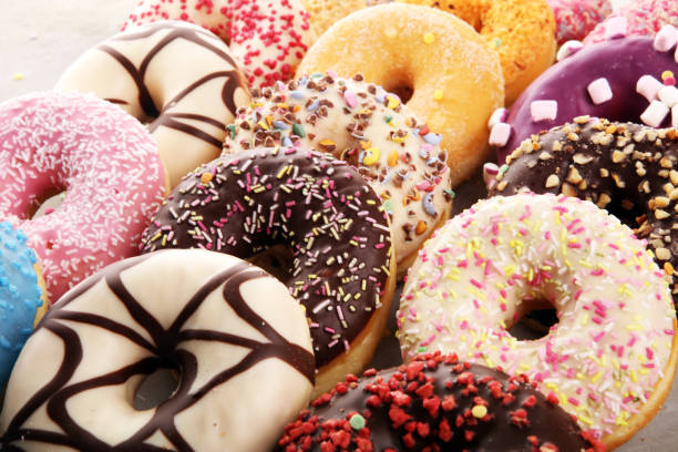 istock assorted donuts with chocolate frosted, pink glazed and sprinkles donuts 1197517476