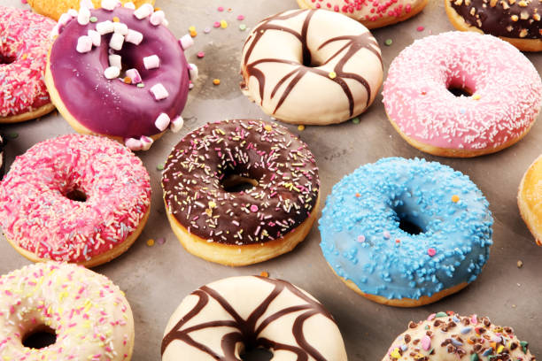 istock assorted donuts with chocolate frosted, pink glazed and sprinkles donuts 1197517561