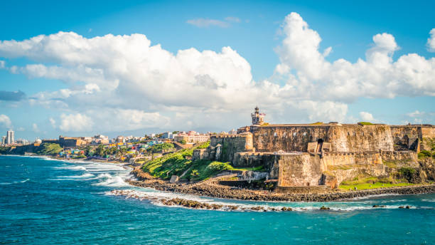 Panoramic landscape of historical castle El Morro along the coastline, San Juan, Puerto Rico. Colorful image with fortification Castillo San Felipe del Morro along the coastline in San Juan, Puerto Rico.  Blue sky and white clouds. puerto rico photos stock pictures, royalty-free photos & images