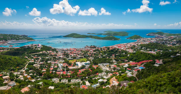 Panoramic landscape view of city, bay and cruise port of Charlotte Amalie, St Thomas, US Virgin Islands. Beautiful colorful and panoramic image of St Thomas. Blue sky, White clouds, sea, mountains, houses and cruise ports with ships in the background. st. thomas virgin islands photos stock pictures, royalty-free photos & images
