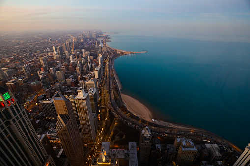 Taken this picture of the Chicago downtown at sunset. IN the picture is well lit up city and the traffic on the street.
