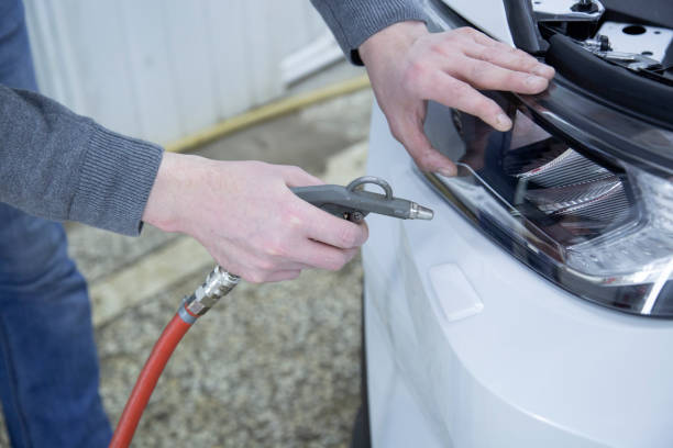 istock Installing a protective film on the car body 1197519709
