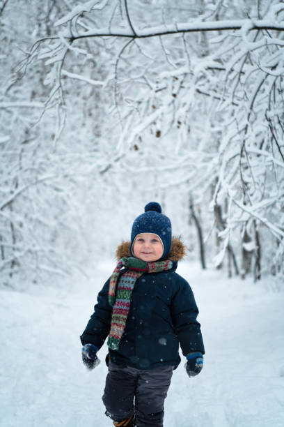 istock Happy child walking through winter forest 1197523735