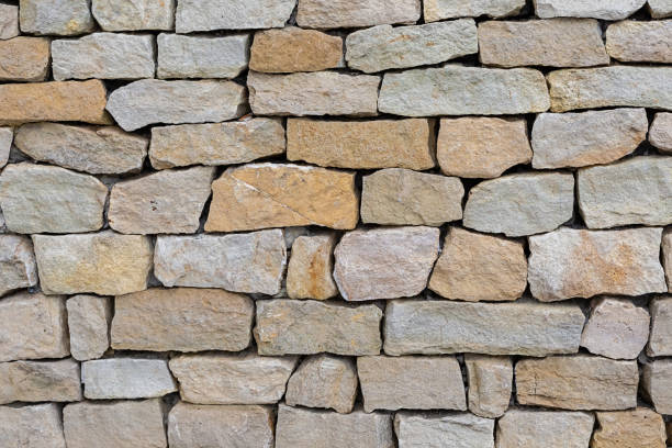 istock stone wall pavement background beige and brown hard natural pattern 1197525091