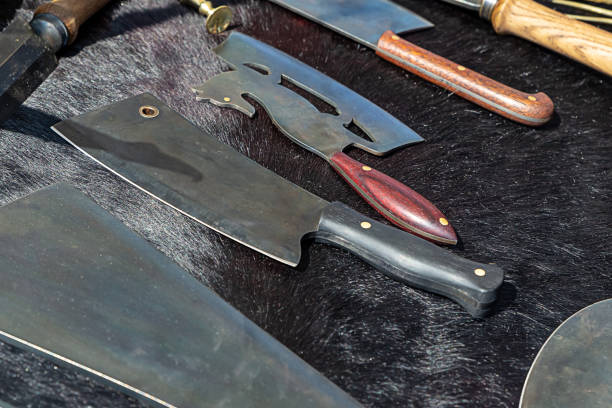 istock knife and ax iron silver counter gunsmith on a black background 1197527463