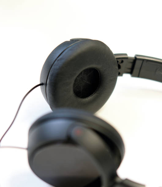 istock Classic black wired headphones on white background. Minimalistic music concept 1197529098