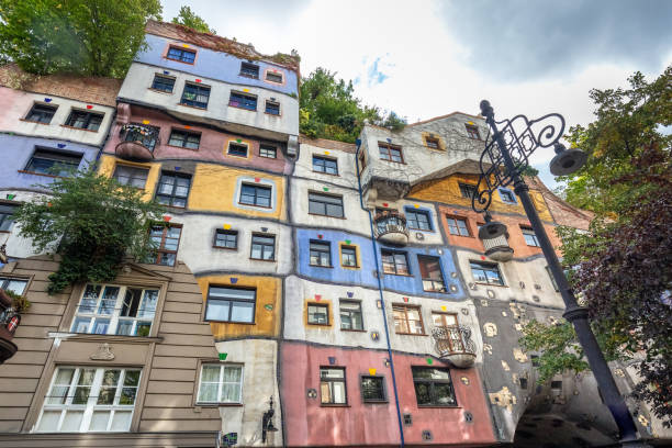 Europe capital cities attractions Hundertwasser house, Hundertwasserhaus - apartment house, idea and concept of Austrian artist Friedensreich Hundertwasser. Colorful facade with growing autumn trees. Vienna, Austria - October 20 2019. hundertwasser house stock pictures, royalty-free photos & images