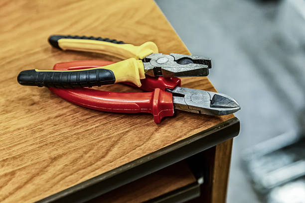 istock pair pliers bright handles red yellow on a wooden table working engineer 1197532697