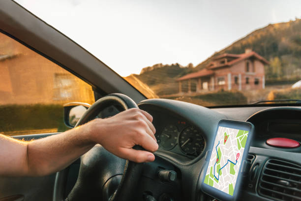 istock Man using his cell phone Gps in the car 1197533155