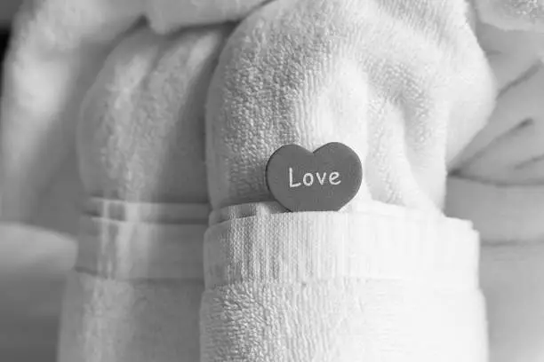 towel white symbol of love heart tinted background, composition decor room wedding newlyweds
