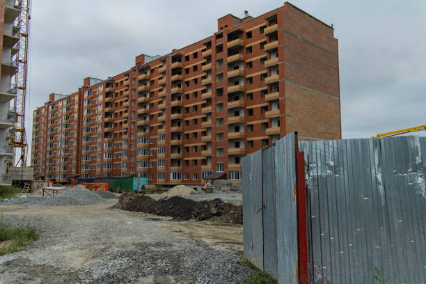 istock construction building fenced territory in gray depressed day weather 1197533943