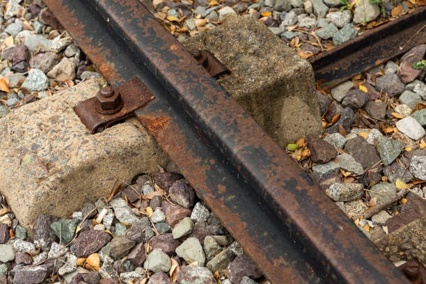 istock iron rusty rail on a concrete gray tie with a close-up closeup 1197538623